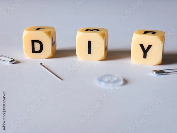 Fototapeta diy do it yourself sewing concept with needle safety pins and button on white background