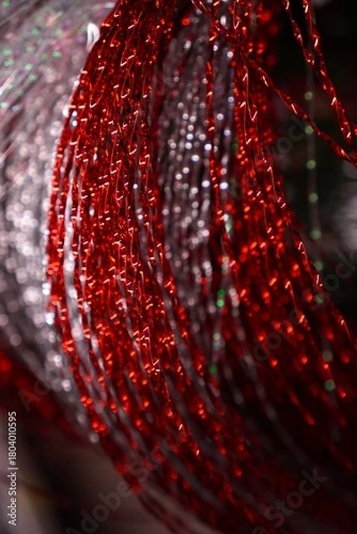 Fototapeta  Detailed closeup of shimmering red metallic wire coils intertwined in an intricate pattern. The vibrant strands reflect light, creating a dynamic and dazzling visual effect