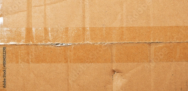 Fototapeta  Surface of plain cardboard box with transparent plastic covering