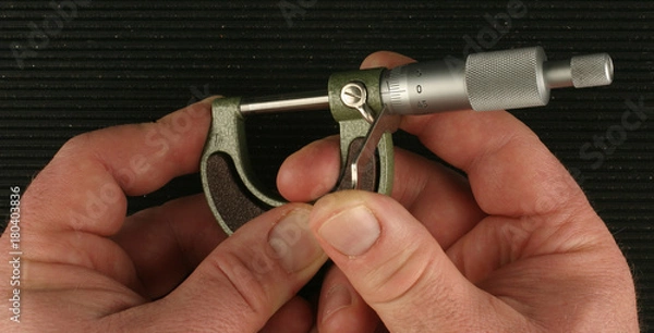 Obraz Metric Micrometer, zeroing, black ribbed toolbox mat background