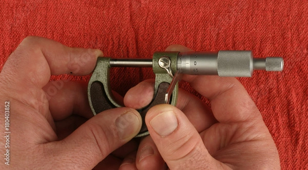 Obraz Metric Micrometer, zeroing, red shop towel background