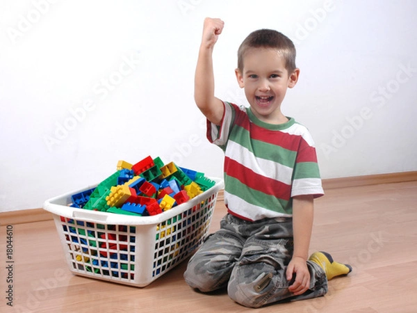 Fototapeta boy playing with plastic blocks