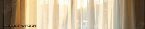 Obraz Sheer Cream Curtains Billowing in Sunlight, Creating a Soft and Airy Atmosphere in a Sunlit Room. Perfect for Adding Sophistication and Privacy to Any Interior Space.