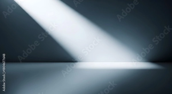 Obraz Dramatic spotlight beam illuminating a dark empty room with a reflective floor surface