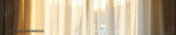Fototapeta Sheer Cream Curtains Billowing in Sunlight, Creating a Soft and Airy Atmosphere in a Sunlit Room. Perfect for Adding Sophistication and Privacy to Any Interior Space.
