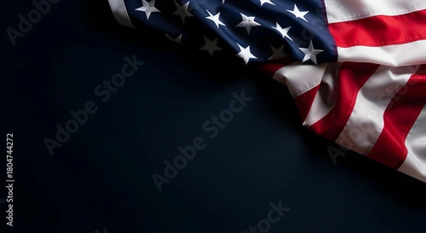 Fototapeta An image showcasing the American flag draped in the corner with a dark background creating a striking visual, evoking themes of patriotism and national pride, suitable for symbolic illustration with