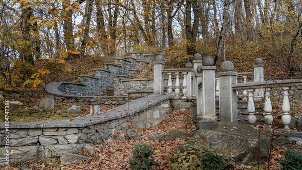 Obraz An old staircase in a park covered with yellow maple leaves. Autumn concept.