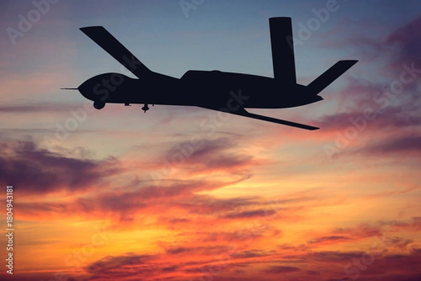 Fototapeta Silhouette of an American MQ-20 Avenger attack and reconnaissance drone at sunset. Illustration of a US Army MQ-20 Avenger unmanned aerial vehicle. Aerial reconnaissance using UAVs in the military.