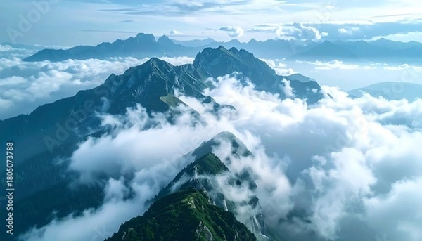 Obraz Misty mountain peaks surrounded by clouds