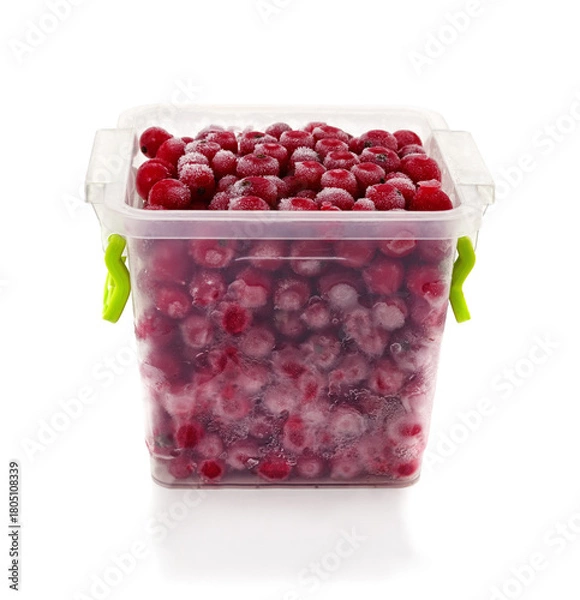 Fototapeta Frozen red berries in plastic container.