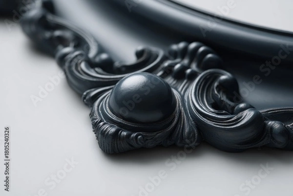 Fototapeta Black baroque frame detail, ornate decorative carving with rich scrollwork and convex elements on a light grey background. Luxurious architectural molding, elegant vintage ornament.