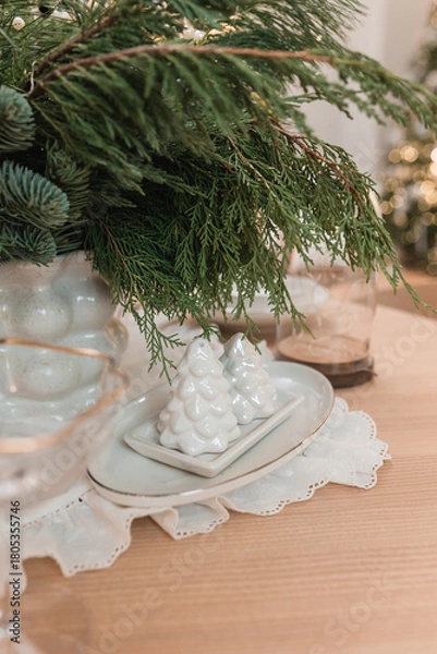 Fototapeta Christmas table decoration with a salt and pepper shaker in the shape of a Christmas tree.