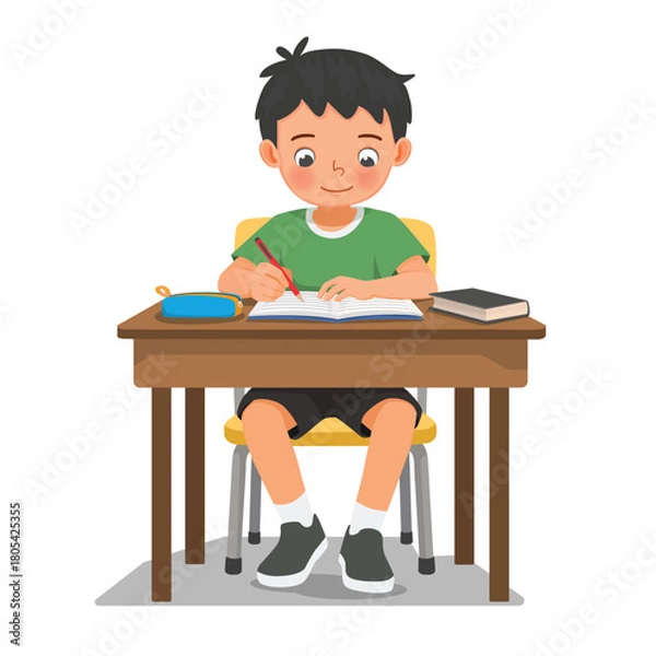 Fototapeta Little boy studying sitting at the desk writing on notebook doing homework