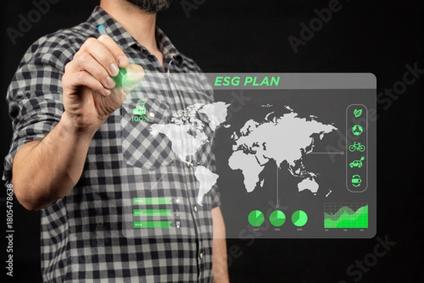 Fototapeta a man holding a digital pen drawing an ESG corporate plan and a corporate sustainability strategy