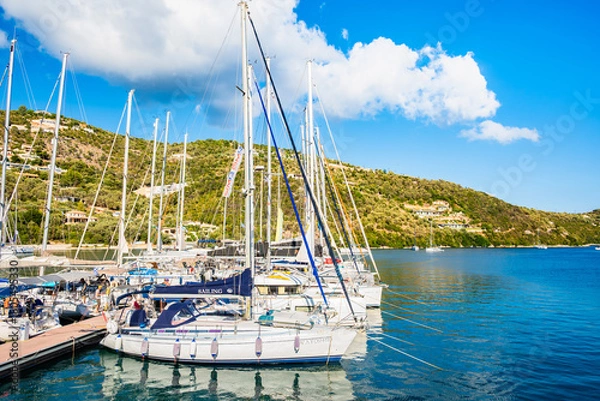 Fototapeta SIVOTA PORT, LEFKADA ISLAND - SEP 25, 2025: Sailing boats anchoring in Sivota port, Lefkada island, Greece.