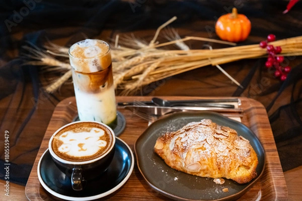 Fototapeta Close up delicious breakfast menu croissant and coffee cup on the wood table in the restaurant.