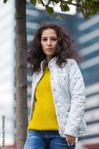 Obraz Portrait of a beautiful girl in an urban landscape in autumn