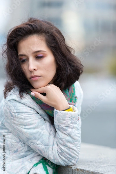 Obraz Portrait of a beautiful girl in an urban landscape in autumn
