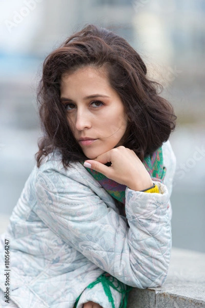 Obraz Portrait of a beautiful girl in an urban landscape in autumn