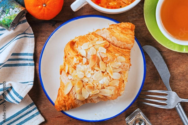 Fototapeta Almond butter croissant on white plate   