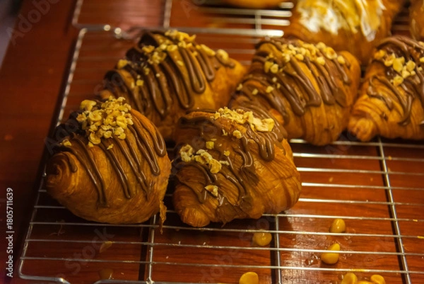Fototapeta Close up photo of tray of golden brown, flaky and look freshly baked croissants in bakery.