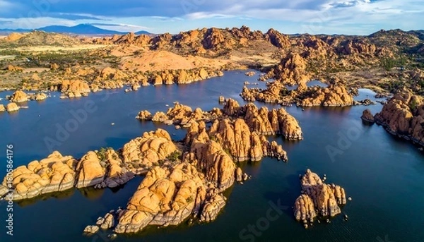 Fototapeta Aerial view of rock formations in a lake, under a blue, partly cloudy sky