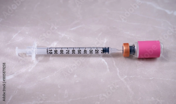 Fototapeta Single Use Syringe Next to Small Glass Vial