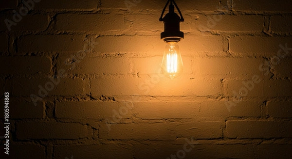 Fototapeta Edison bulb casts warm glow on rustic brick wall creating inviting atmosphere perfect for cozy cafe or vintage design project, bringing a touch of old-world charm and inviting ambiance