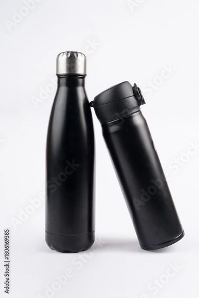 Fototapeta The bright white backdrop highlights the sleek and modern design of both bottles