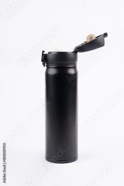 Fototapeta A drinking bottle with its cap opened is placed on a white background, creating a clean and minimal look