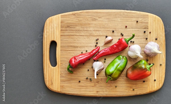 Fototapeta Composition of pepper, chili, garlic, on a wooden surface.