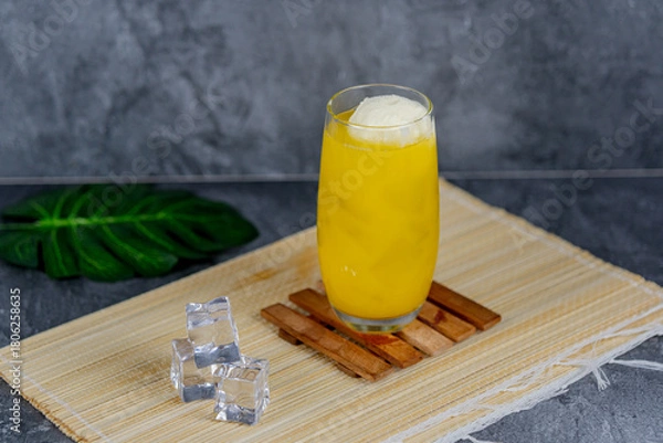 Fototapeta Orange float is a refreshing dessert drink made with creamy vanilla ice cream and fizzy orange soda, combining citrusy, sweet, and creamy flavors for a nostalgic summer treat.