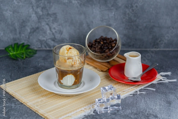 Fototapeta Affogato coffee is a classic Italian dessert featuring a scoop of vanilla ice cream or gelato “drowned” with hot espresso. This indulgent treat offers a perfect blend of bitter and sweet, hot and cold