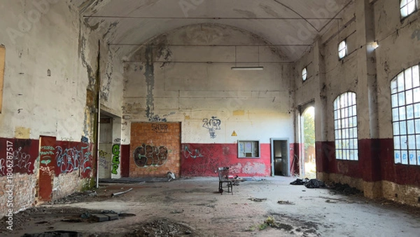 Fototapeta Exploring a forgotten industrial ruin a powerful image of architectural decay structural deterioration vast empty interior