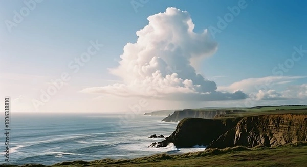 Fototapeta Coastal Cliffs Under a Dramatic Sky with a Large Cloud Formation.