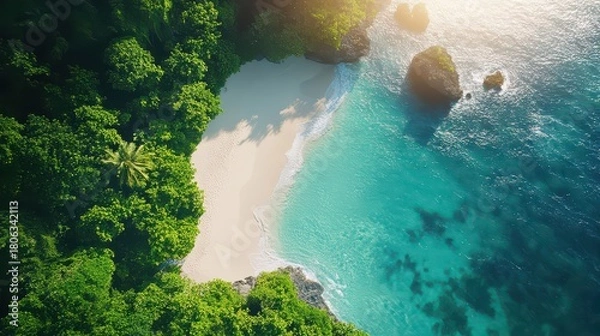 Fototapeta Aerial View of Hidden Tropical Beach Cove with Turquoise Ocean Water and Lush Green Cliffs at Sunrise