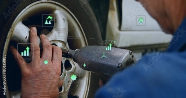Obraz Stabilizing wheel hub and operating impact wrench in workshop, wearing blue shirt with AR overlays