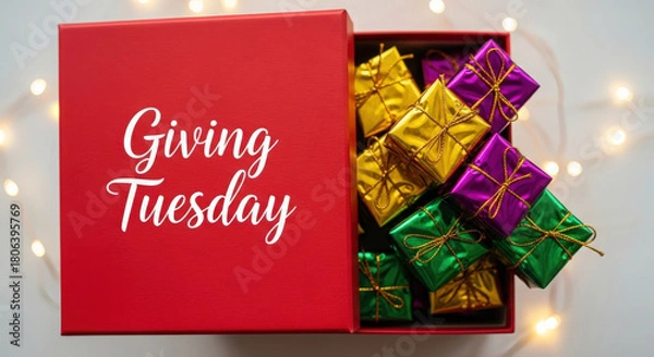 Fototapeta Red gift box filled with colorful wrapped chocolates for giving tuesday celebration