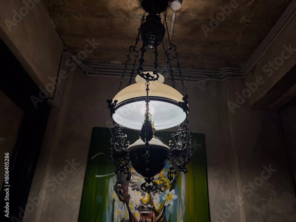 Fototapeta Elegant vintage chandelier illuminates modern art in dimly lit interior for sophisticated design concepts and artistic inspiration