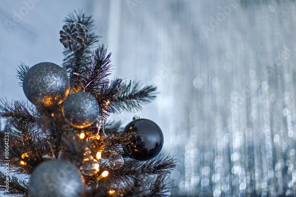 Obraz Christmas dark blurred background with a black Christmas tree, ornaments and bokeh lights