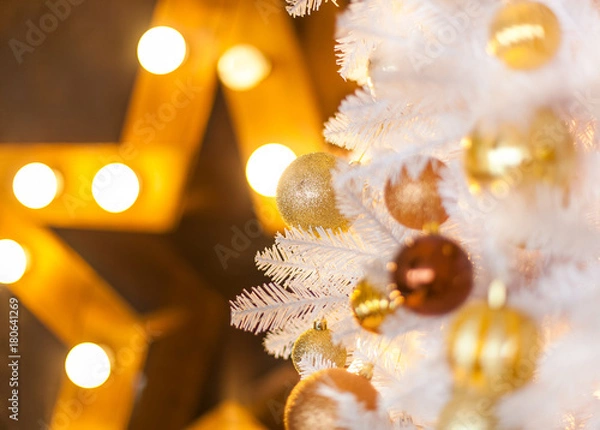 Obraz Festive blurred Christmas background with white Christmas tree, Christmas tree ornaments bokeh lights and electric garland