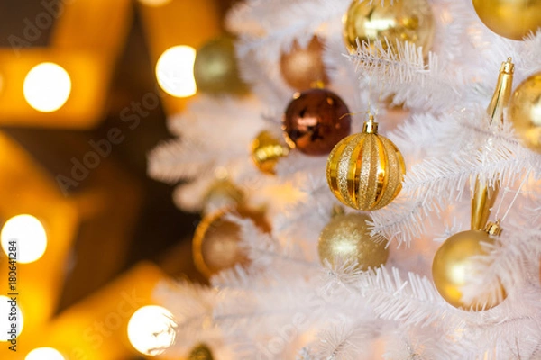 Obraz Festive blurred Christmas background with white Christmas tree, Christmas tree ornaments bokeh lights and electric garland