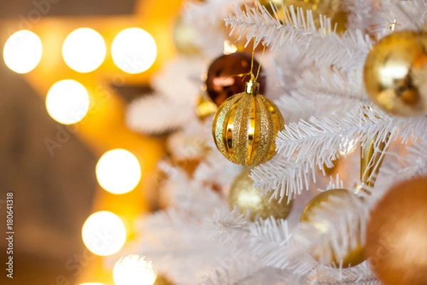 Obraz Festive blurred Christmas background with white Christmas tree, Christmas tree ornaments bokeh lights and electric garland