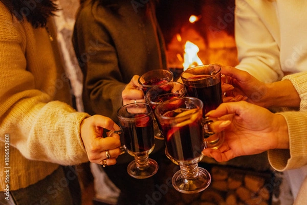 Obraz Close-up of the women saying a toast and clinking glasses with mulled wine