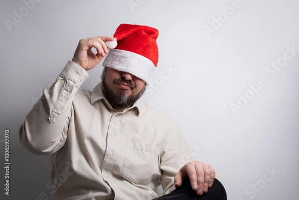 Obraz Man with santa hat pulled over eyes