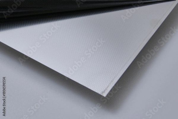 Obraz Close up image of metallic surface sheets with brushed and matte finishes, showcasing industrial texture and modern material design for architecture, manufacturing, and product design applications.