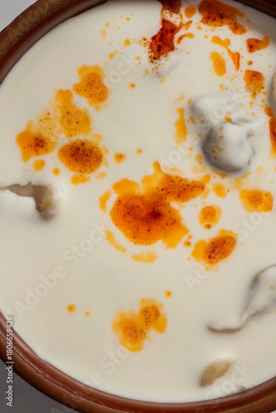 Obraz Traditional Bosnian dumplings — klepe. The dish served with a yoghurt sauce and spices on a wooden table