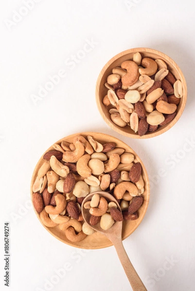 Fototapeta Mixed nuts consisting of almonds, cashews and peanuts, roasted with salt. Healthy snack on white background.