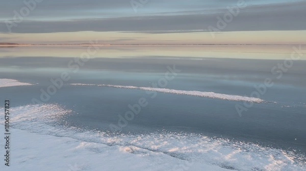 Fototapeta Frozen Reflections: Serene Winter Morning at the Edge of a Snowy Lake, Ice
