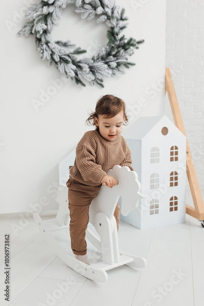 Fototapeta little boy playing with a toy house